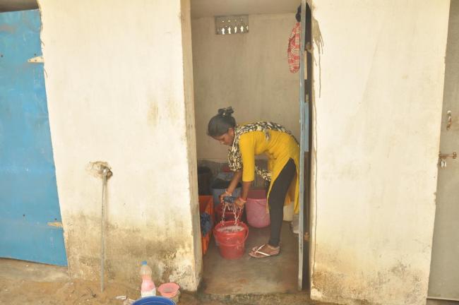Woman in Odisha washing clothes