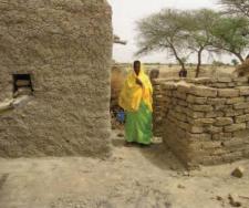 Mariama next to her latrine (© Plan Niger)