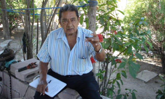 The chair of a water committee in El Salvador checks water quality