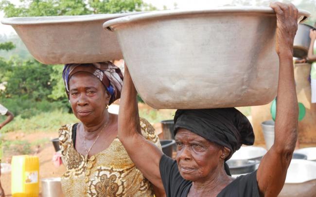 Women carrying water in Wamahinso, Asutifi North District, Ghana