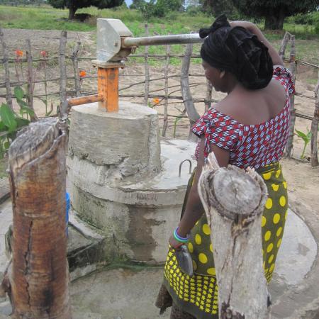 Woman using a rural water pump