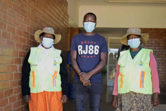 Tafadzwa (middle) with community health workers in Bulawayo, Zimbabwe