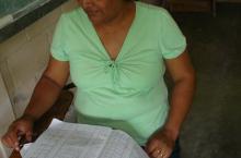 woman checking the financial records of the water committee