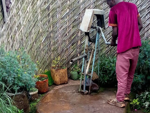 A data collector checking the functionality status of a water point