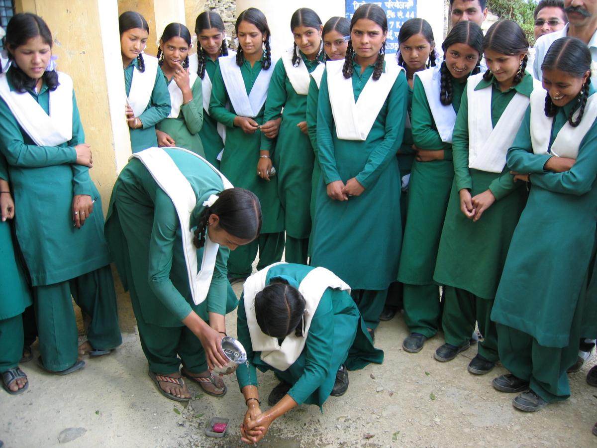 Girls washing hands, Uttaranchal, India, 2006. 