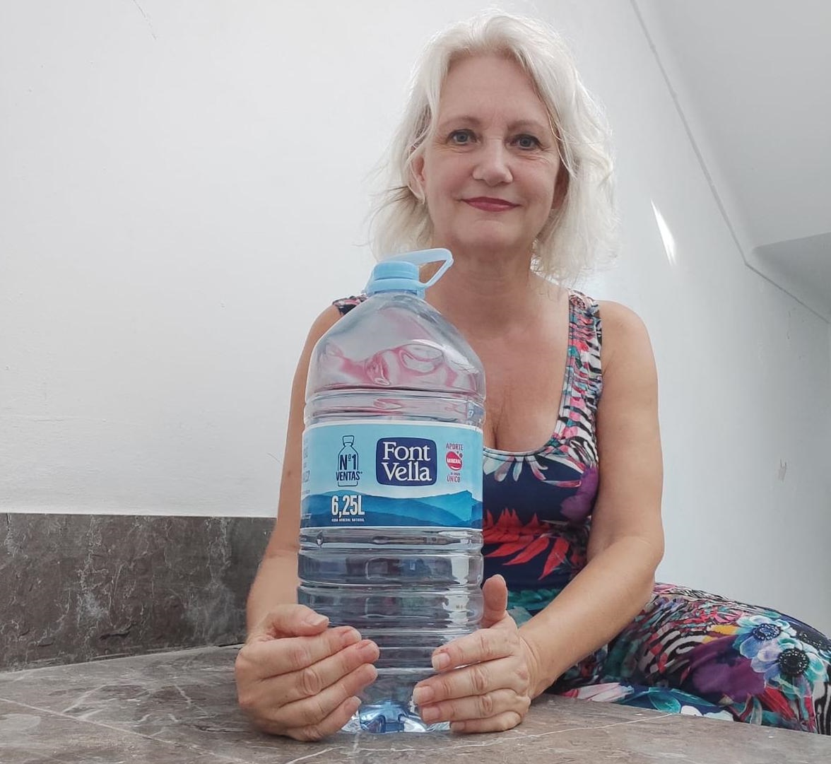 Marion holding 6 liter water bottle