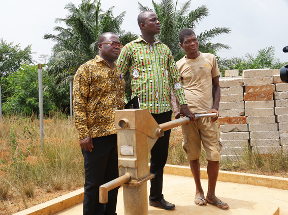 Odeb Amos Telvi, Wassa East Environmental Health Officer, left, Anthony Quaicoe, Planning Development Officer (centre) and Kwabena Nkrumah, sub chief, with the new pump in Nyekonakpoe community